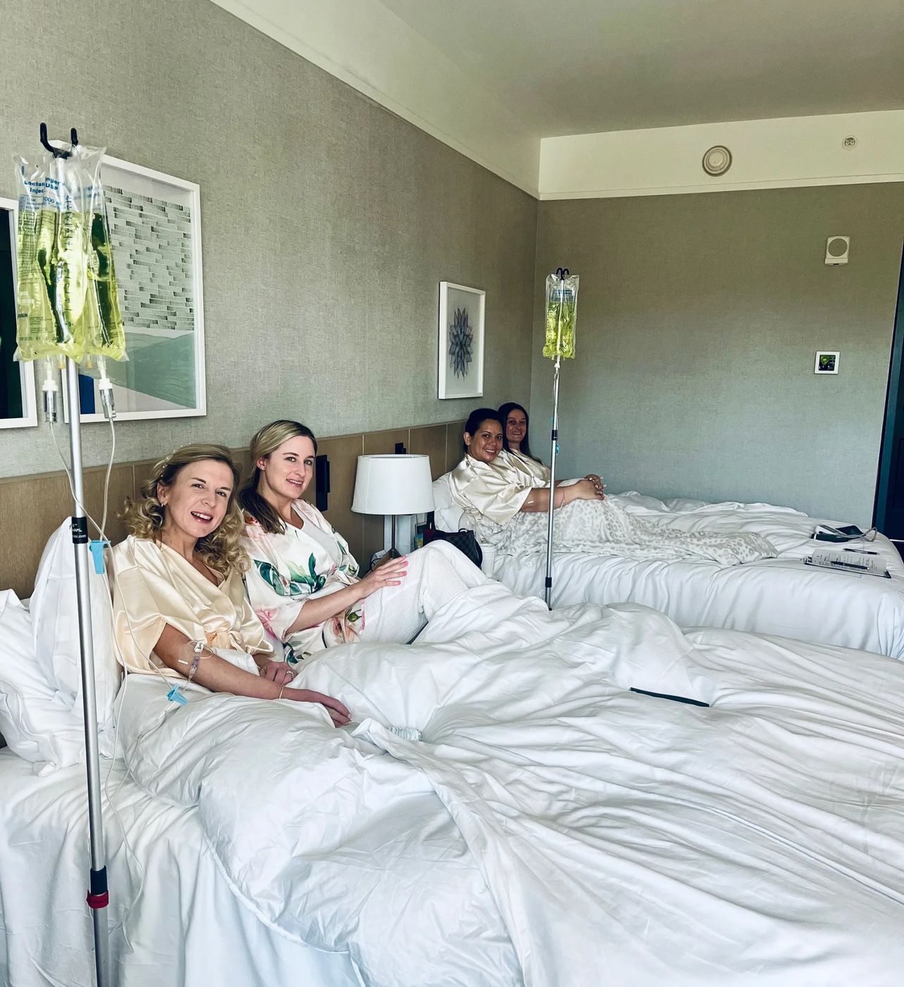 A group relaxing in a hotel room during IV drips