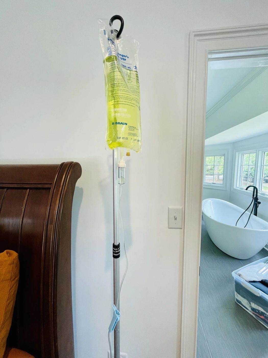 IV drip set up in a bright bedroom